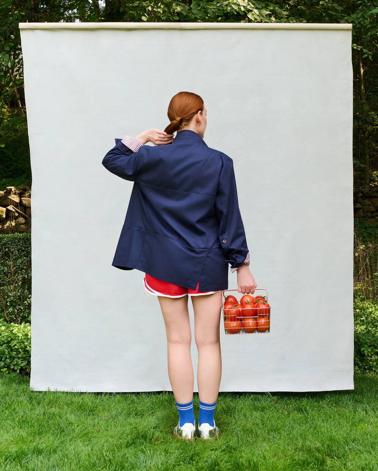 Female model wearing the navy Farnsworth Chore Coat, back view.