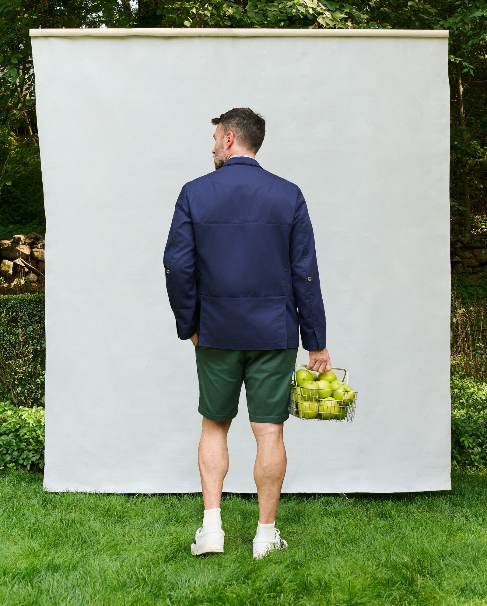 Male model wearing the navy Farnsworth Chore Coat, back view.