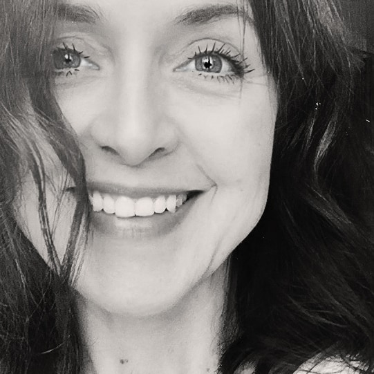 Black-and-white close-up portrait of Gabriella Zanzani smiling.