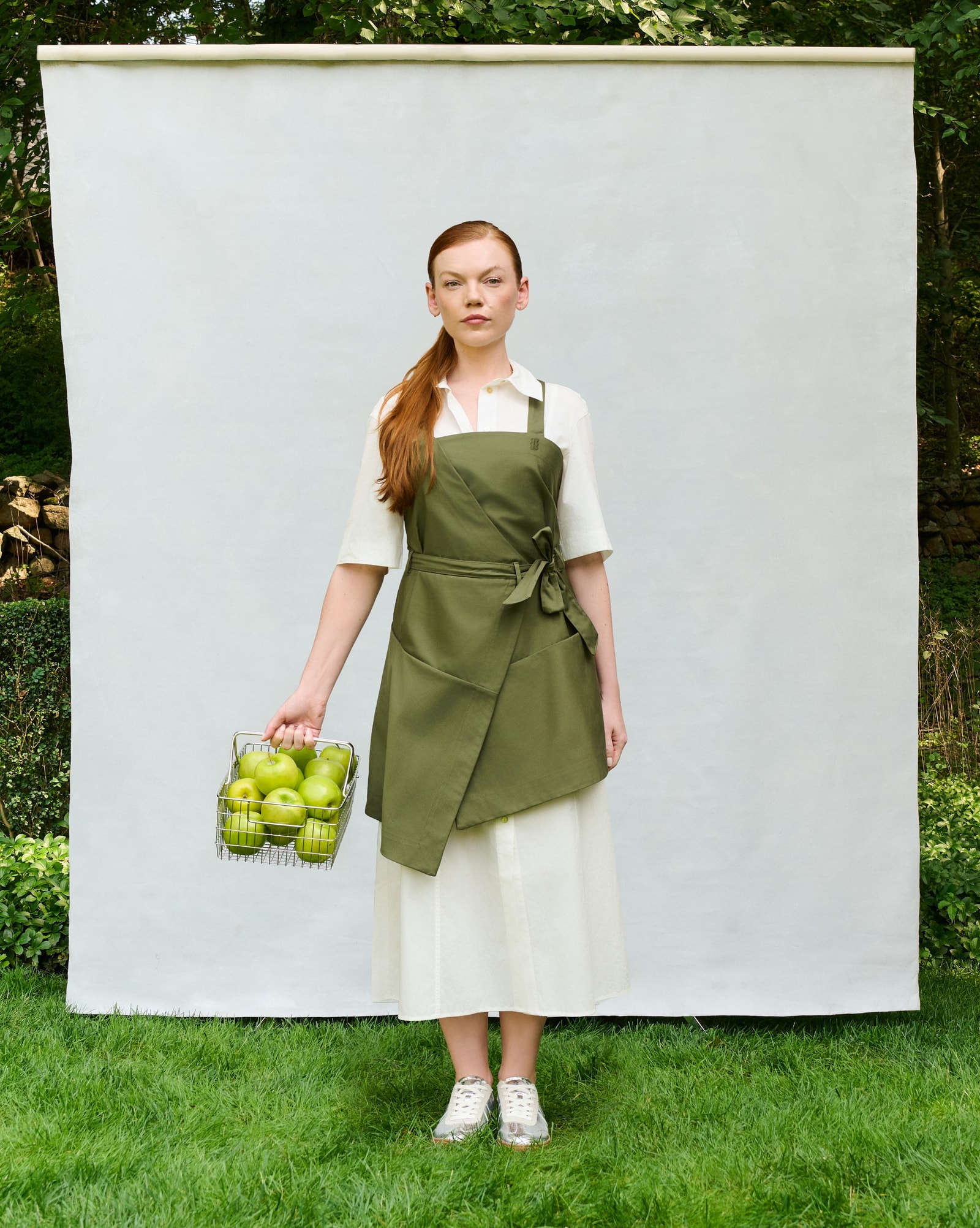 Model wearing the olive Trigo Apron, front view.