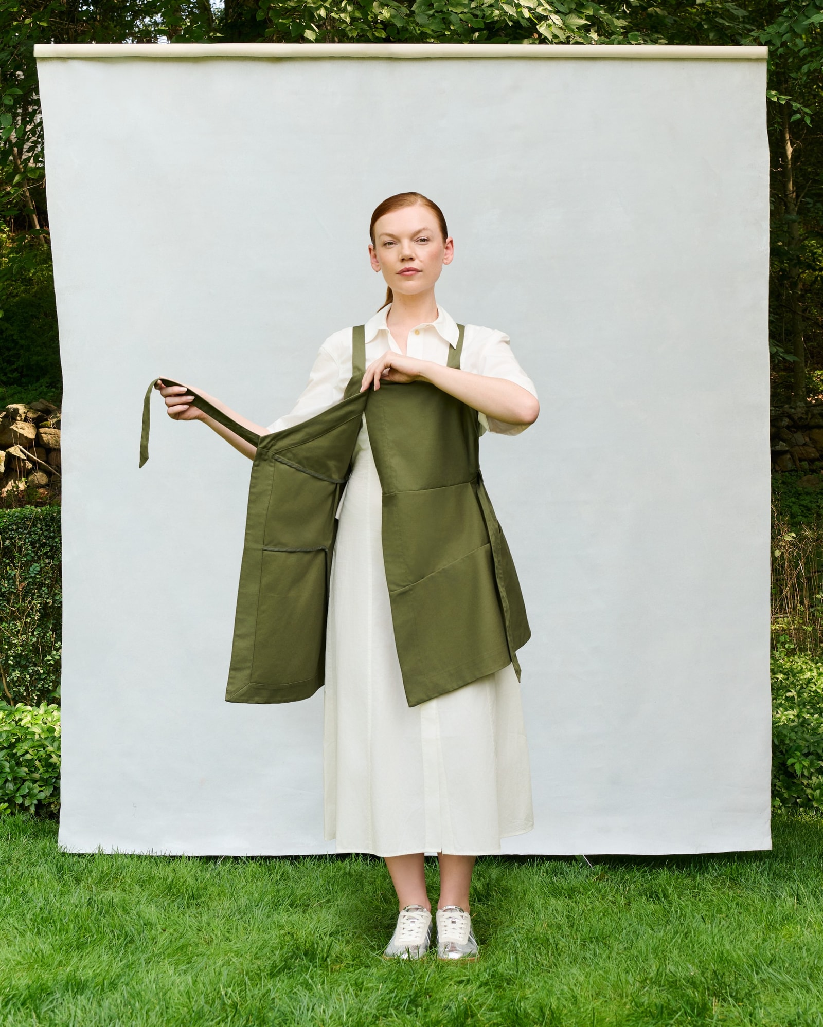 Model showing the olive Trigo Apron semi-open.